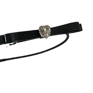 Elegant black bow headband with a large sparkling heart-shaped crystal center