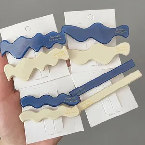 Klein blue and beige acetate hair clips in wavy and geometric shapes for women
