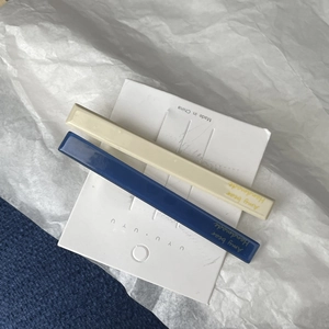 Detail view of rectangular blue and cream acetate hair clips set on a display card
