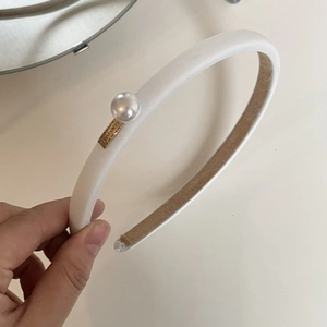 French vintage white headband with large pearl detail and golden metal logo plate