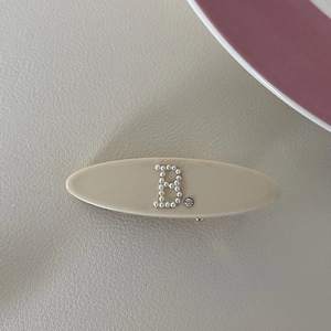 French style oval pearl hair clip with letter B and rhinestone on cream acetate base