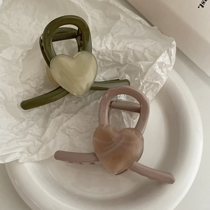 Elegant heart-shaped hair claw clips in olive green and dusty pink resin finishes