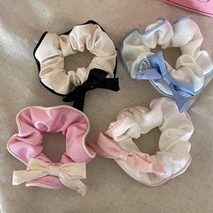 Elegant satin bow scrunchies set in four soft pastel colors for a stylish ballet look