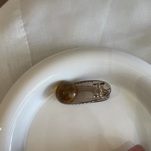 Translucent amber resin heart hair claw clip with vintage brown finish and gold spring
