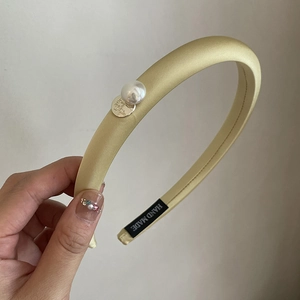 Elegant yellow satin sponge headband with pearl accent and handmade metal tag for women