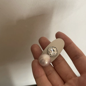 Dettaglio di un fermaglio per capelli con perla viola e cristallo su base albicocca