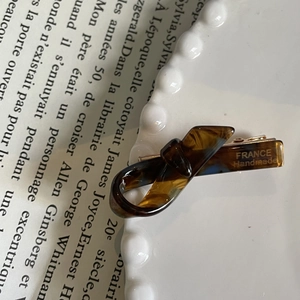 Close-up of tortoise shell pattern acetate hair clip with France Handmade engraving