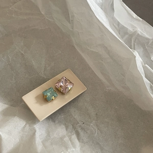 Elegant gold square-cut stud earrings with light blue and pink gemstones set on card