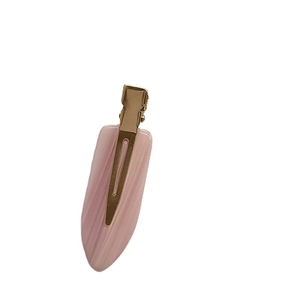 Elegant pink acetate hair clip with gold metal buckle for women in a minimalist style