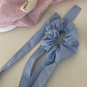 Elegant light blue ribbon scrunchie with long streamers for elegant hair styling