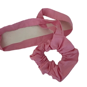 Pink fabric hair accessory set featuring wide headband and scrunchie for women