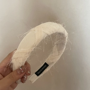 Chic handmade cream woven headband with fringe texture and high top volume design
