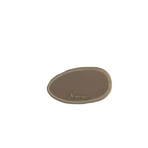 Brown acetate hair clip with golden Nuance lettering and elegant oval design