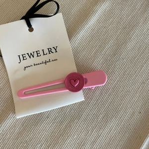 Nahaufnahme der rosa Herz-Haarspange mit mattem Finish auf eleganter Displaykarte