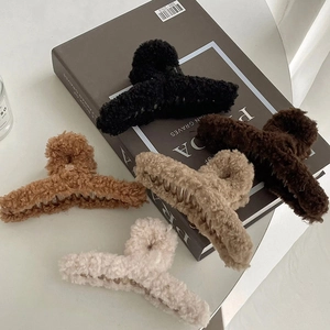 Furry plush oversized claw clips in black, brown, and beige with soft lamb wool texture