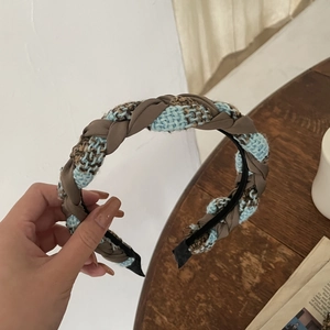 Detail of blue and brown checkered sponge headband with woven texture for hair styling