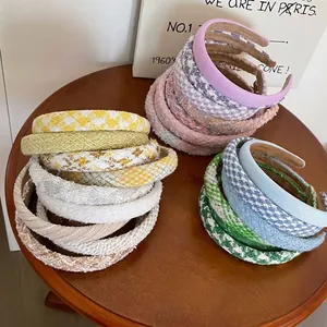 Elegant plaid tweed headband in various pastel colors featuring a retro textured fabric style