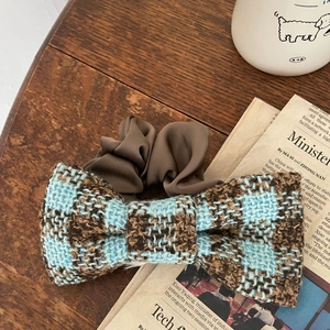 French style blue plaid tweed bow hair tie with brown silk scrunchie on wooden desk