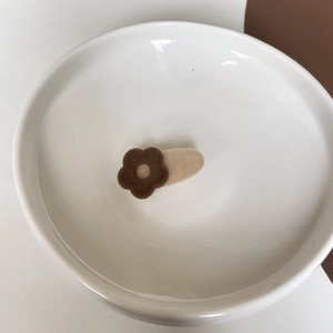Milk tea flower hair clip with flocking texture in a ceramic bowl for elegant styling