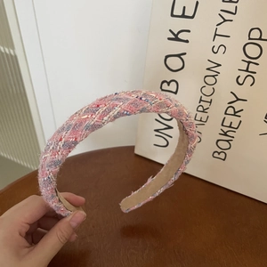 Close-up of pink and blue tweed headband showing woven texture and non-slip lining