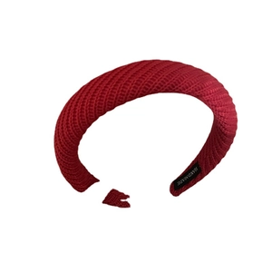 Red handmade knit headband with elegant diagonal weave and interior brand tag