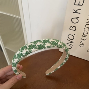 Detail of green and white houndstooth fabric headband with thick sponge padding