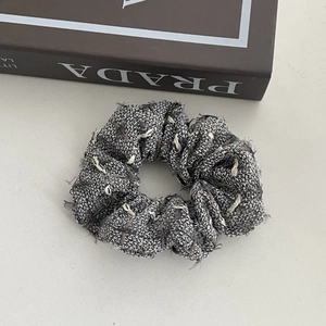 Detailed view of the tweed fabric texture and frayed edges on this vintage headband