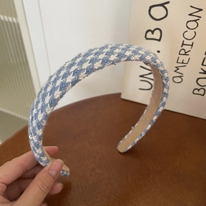 Close-up of blue and white plaid tweed headband with sequins and non-slip velvet lining