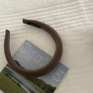 Thick brown sponge headband in soft knit wool texture with handmade label detail