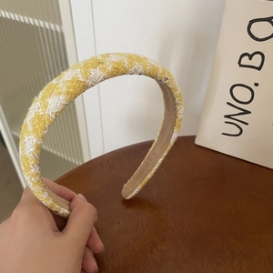 Detail of yellow plaid tweed headband with non-slip velvet inner lining texture