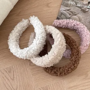 Fluffy lamb wool headbands in multiple colors displayed on a cozy wooden background
