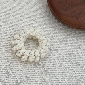 Beige plush telephone coil hair tie with soft wool texture for daily styling