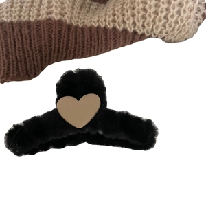 Winter plush black hair claw clip with a matte beige heart on knit background