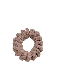 Elastic plush hair scrunchie in dusty pink boucle texture for versatile daily hairstyling