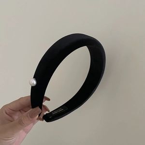 Detail of vintage black velvet headband with pearl accent and handmade label