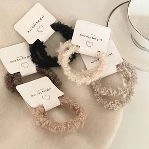 Five-piece set of plush lamb wool hair scrunchies in warm earthy milk tea colors
