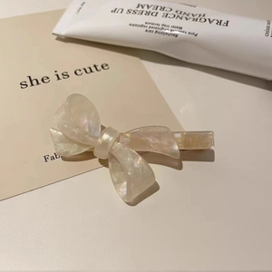Elegant French style pearlescent white acetate bow hair clip with shimmering glitter finish