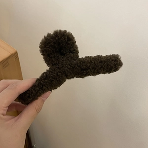 Close-up of deep brown plush faux fur hair claw clip showing soft teddy fleece texture