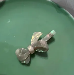 French style green acetate bow hair clip with iridescent pearlescent finish and metal grip