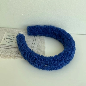 Close-up of deep blue teddy fleece headband with plush textured fabric detail