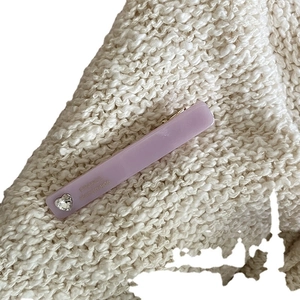 Lavender acetate rectangular hair clip with a heart rhinestone on a knit background