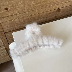 Close-up of the plush faux rabbit fur material and sturdy hinge on the large white hair claw