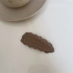 Minimalist milk tea brown lace fabric bow hair clip for girls on a white background