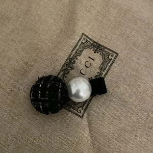 Vintage style duckbill hair clip with black tweed ball and white pearl on retro fabric