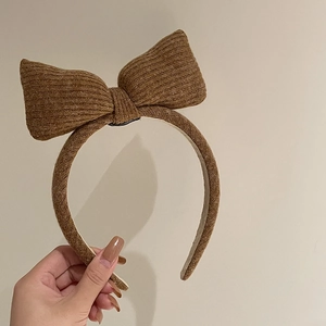 Brown knitted headband with oversized bow and ribbed texture for women hair accessory