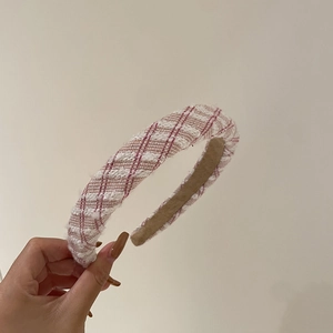 Detailed close-up of pink and white tweed woven wide headband with soft texture