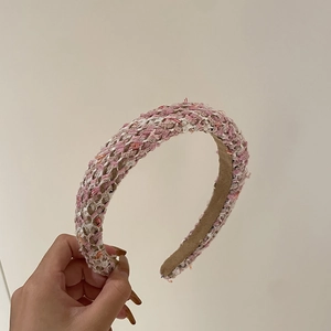 Detail of pink and white tweed braided wide headband with soft interior fabric texture