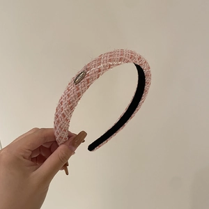 Detail of pink and white tweed headband with silver sparkle and gold metal accent