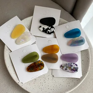 Set of minimalist teardrop hair clips in matte colors and tortoiseshell acetate patterns