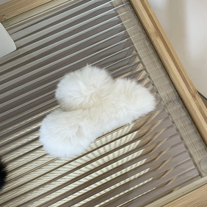 Plush white faux rex rabbit fur hair claw clip for women on a stylish glass tray
